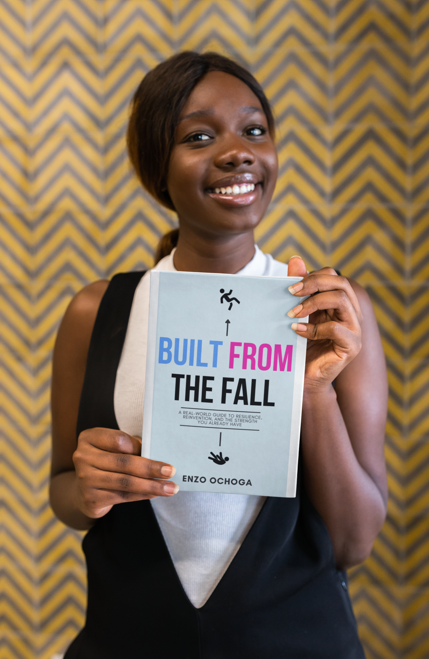 Woman holding Built From The Fall book